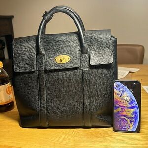 A very classic mulberry style black backpack with real leather